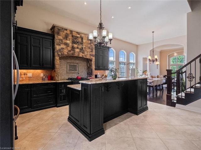 Raised breakfast bar at island. Granite countertops. Soft close cabinetry. Valance and pot lighting make for a well lit cooking space. | Image 3