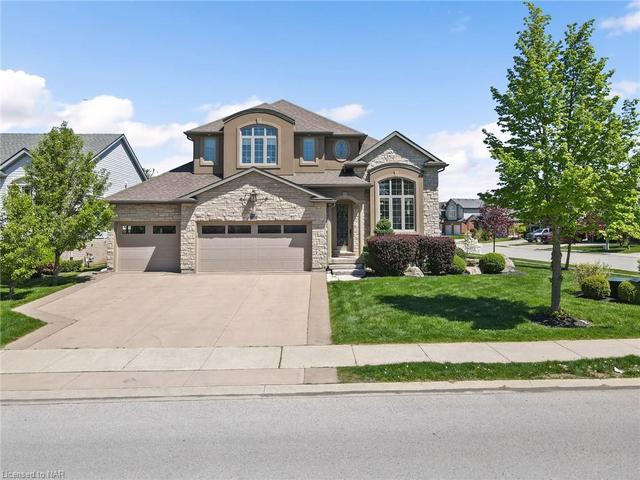 Sensational curb appeal on a corner lot makes this home STAND OUT! Heated 3-car garage and a stamped concrete driveway make for plenty of parking. | Image 1
