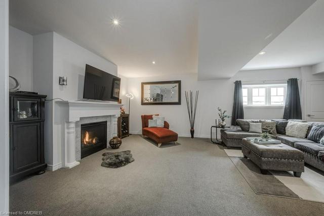 Lower Level Rec Room with so much natural light and gas fireplace. | Image 29
