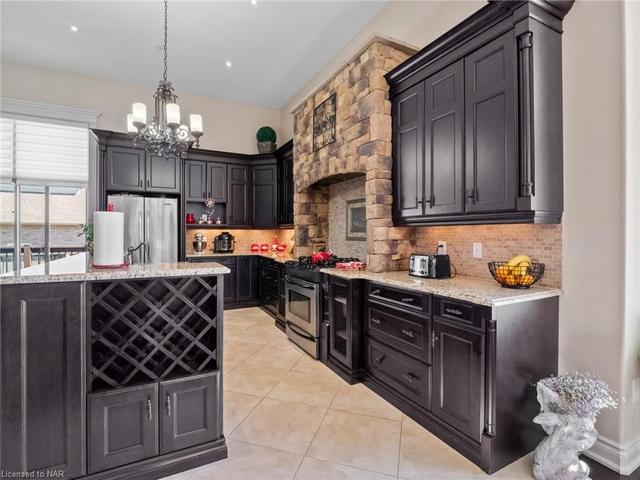 The dark and rich tones of the Kitchen and stone feature harken to a classic European appeal. | Image 2