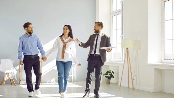 A couple tours a home with a real estate agent.