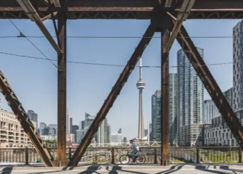 Man biking on bridge in Toronto