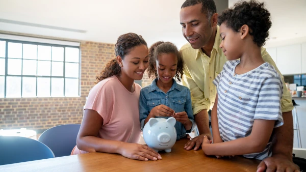 A family saving money in a piggy bank