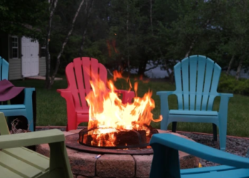 A backyard fire pit surrounded by chairs