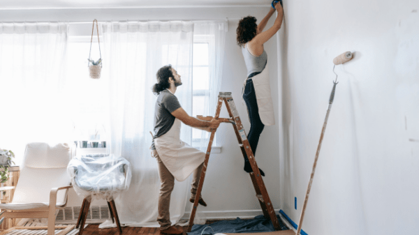 Couple painting their home white