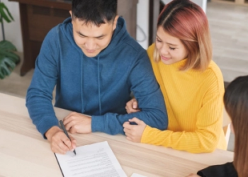 A couple looks at financial documents together