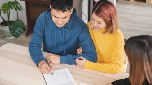 A couple looks at financial documents together