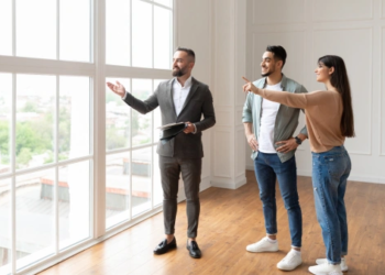 A couple view a condo apartment with a real estate agent.