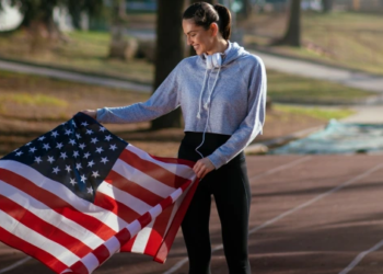 An athlete holding USA flag.