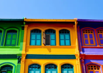 Green, yellow, purple homes in a row.