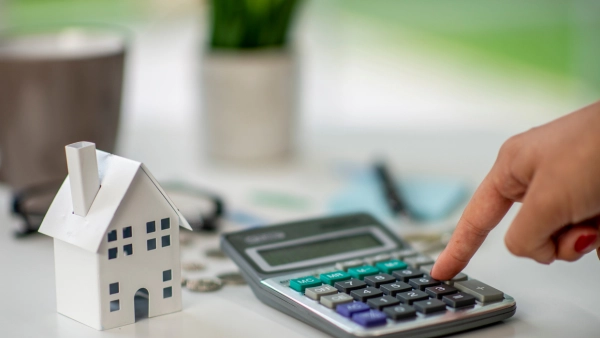 A small home next to a calculator