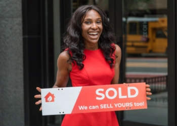 new homeowner holding up sign