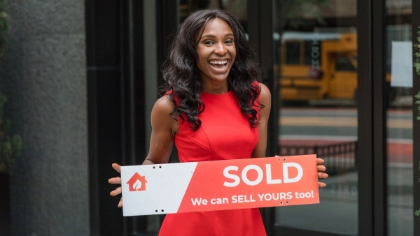 new homeowner holding up sign