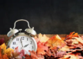 A clock in a pile of leaves.