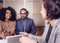 Two people talking to a financial advisor.