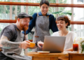 baristas looking at a laptop in a coffee shop