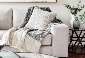 A chunky blanket on a sofa.