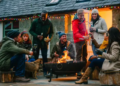 An outdoor fire pit surrounded by a group of people.