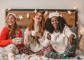 Friends celebrating the holidays in a decorated bedroom.