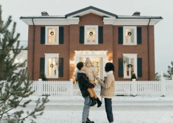 Family outside of house in winter