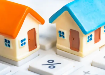 Two small houses on top of a keyboard