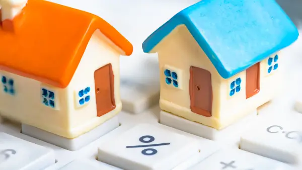 Two small houses on top of a keyboard