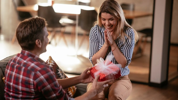 A person gifting a present to someone.