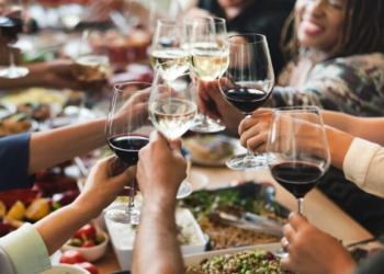 A group of people clinking glasses together.