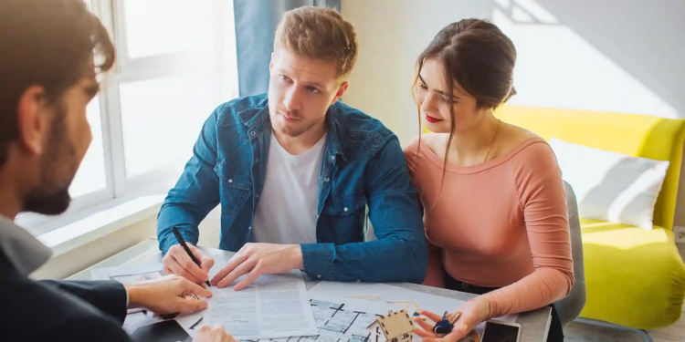 A couple talks about finances with a real estate agent.